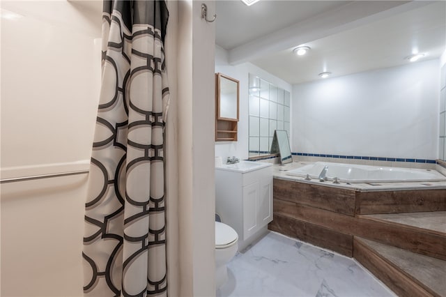 bathroom featuring vanity, toilet, and tiled tub