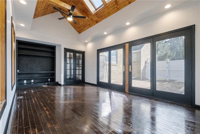 unfurnished living room featuring french doors, dark hardwood / wood-style floors, a healthy amount of sunlight, and a skylight