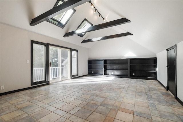 interior space with beamed ceiling, track lighting, high vaulted ceiling, and a skylight