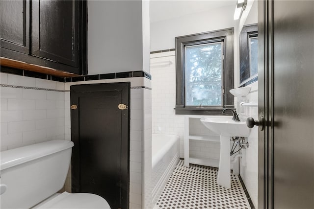 bathroom with tile walls, plus walk in shower, toilet, and tile patterned flooring