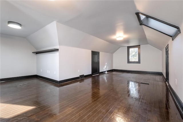 bonus room with lofted ceiling and dark hardwood / wood-style floors