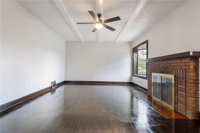 unfurnished living room with dark wood-type flooring, a fireplace, and ceiling fan