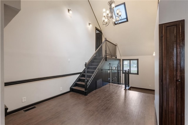 stairway with lofted ceiling and hardwood / wood-style flooring