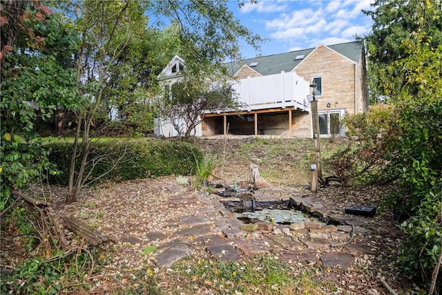 back of house featuring a wooden deck