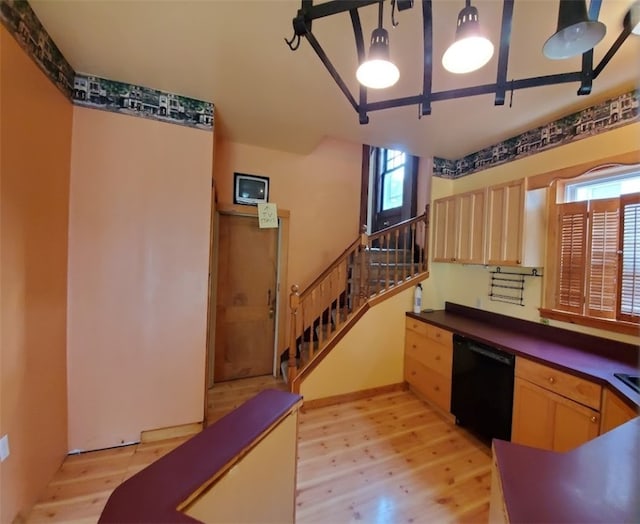 kitchen with light wood-type flooring, light brown cabinetry, dishwasher, and pendant lighting