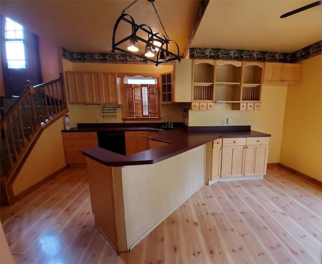 kitchen with dishwasher, light hardwood / wood-style floors, sink, a notable chandelier, and beam ceiling