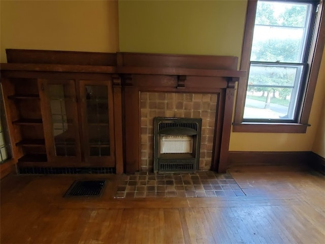 room details with wood-type flooring and a fireplace