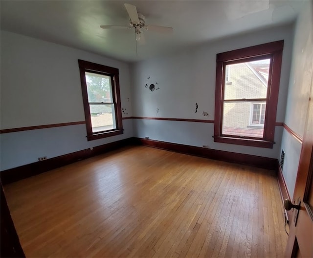 unfurnished room with ceiling fan, light hardwood / wood-style floors, and a wealth of natural light