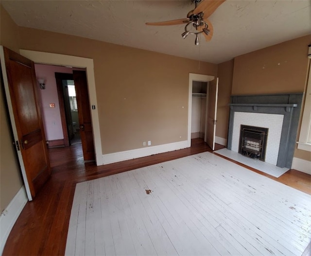 unfurnished living room with dark hardwood / wood-style floors and ceiling fan