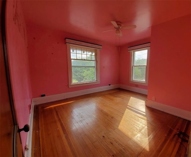 spare room featuring light hardwood / wood-style floors and ceiling fan