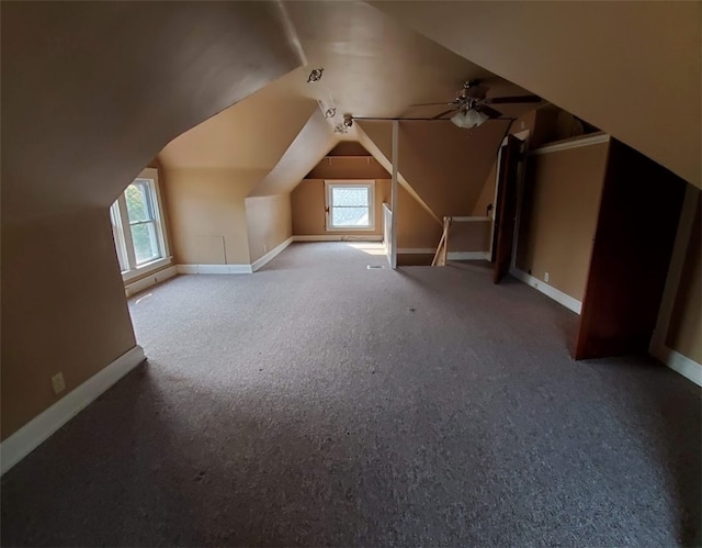 additional living space featuring carpet flooring, lofted ceiling, and ceiling fan