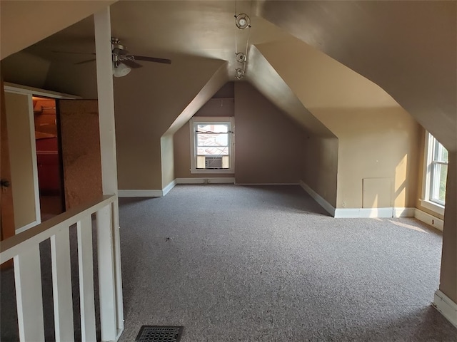 bonus room with cooling unit, lofted ceiling, ceiling fan, and carpet flooring