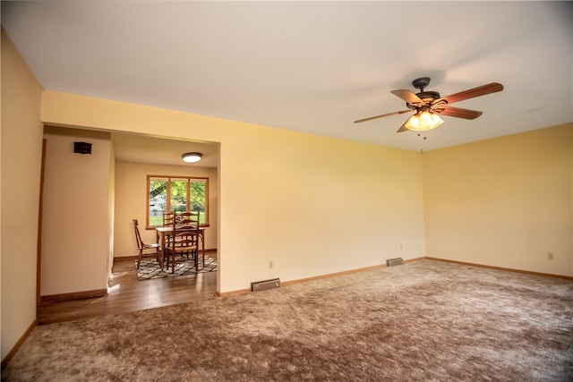 empty room featuring ceiling fan and dark hardwood / wood-style floors