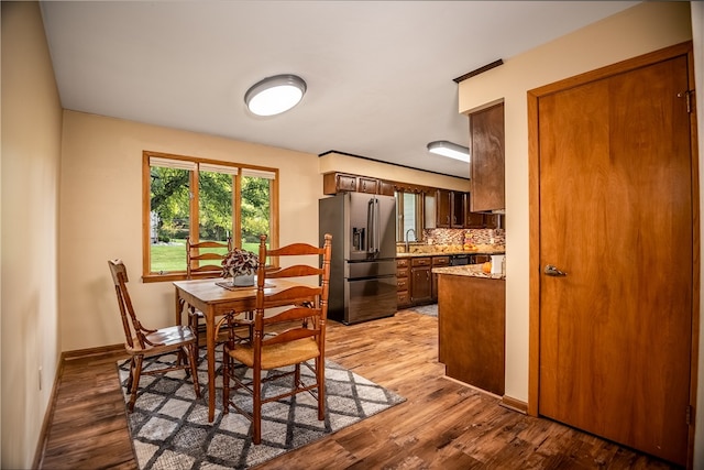 dining area with light hardwood / wood-style floors and sink