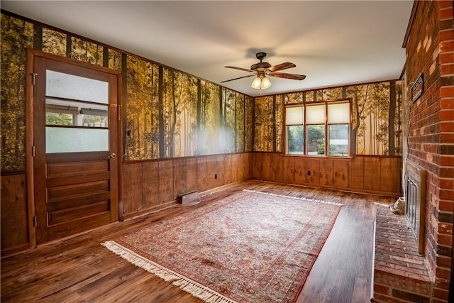 unfurnished room with wood-type flooring, ceiling fan, and a healthy amount of sunlight