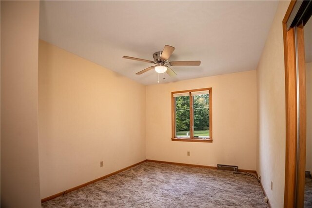 spare room with ceiling fan and carpet flooring