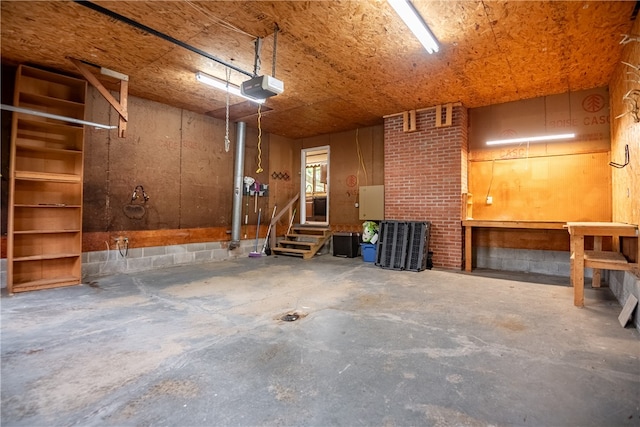 garage with a garage door opener and a workshop area