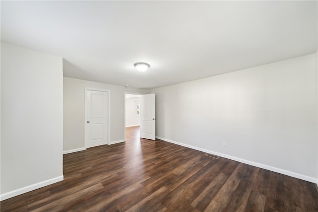 empty room featuring dark hardwood / wood-style flooring