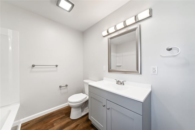 bathroom with wood-type flooring, vanity, and toilet