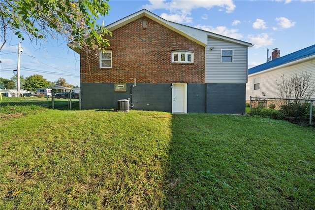 back of house with a lawn