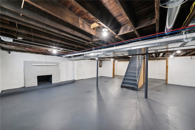 basement featuring a brick fireplace