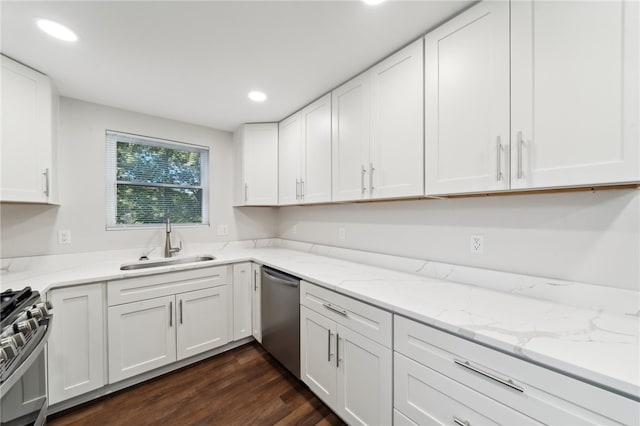 kitchen with stainless steel appliances, white cabinetry, and sink