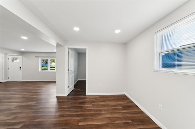 empty room with dark hardwood / wood-style flooring