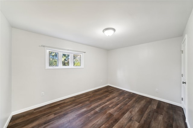 spare room with dark hardwood / wood-style flooring