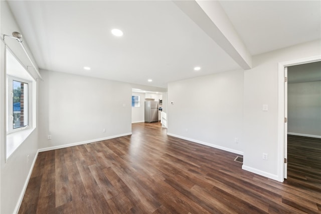 unfurnished living room with dark wood-type flooring