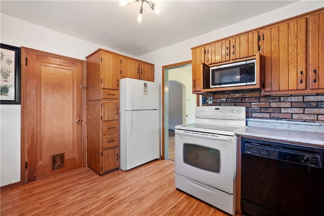 kitchen featuring light wood-type flooring and white appliances