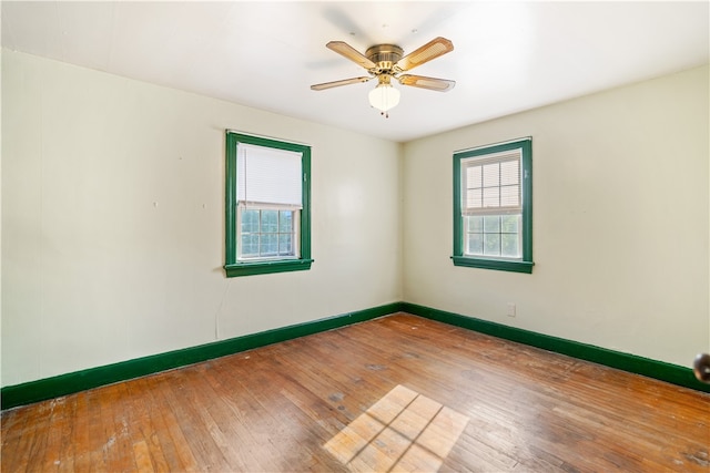 spare room with ceiling fan and hardwood / wood-style flooring