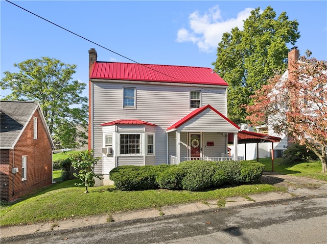 view of front of property with cooling unit, a front lawn, and a porch