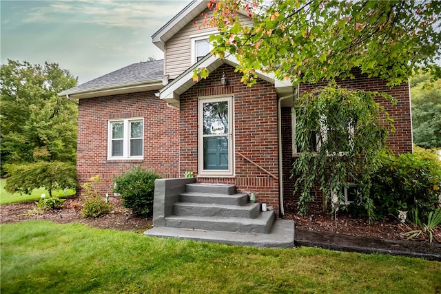 doorway to property featuring a yard