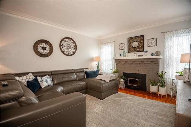 living room with wood-type flooring, a brick fireplace, and crown molding