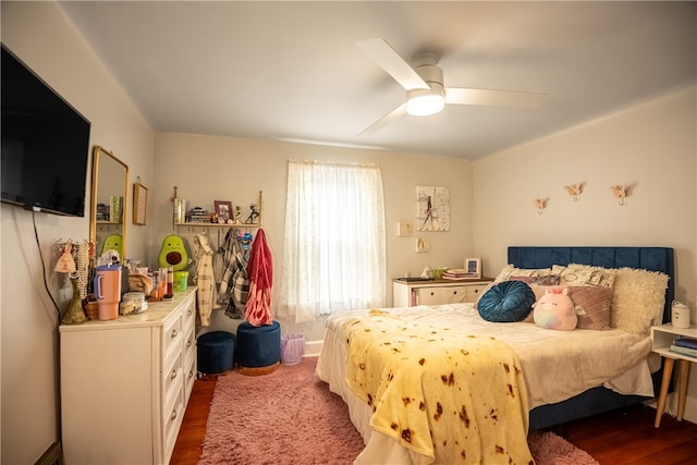 bedroom with ceiling fan and dark hardwood / wood-style flooring