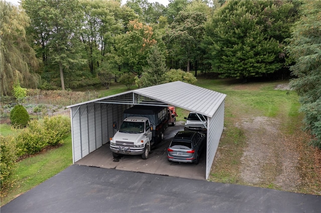 view of parking with a lawn and a carport