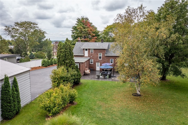 rear view of house with a patio area, a gazebo, and a yard