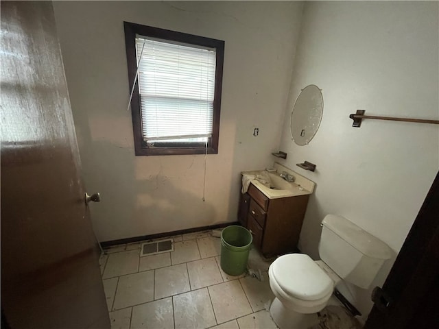 bathroom with vanity, toilet, and tile patterned floors