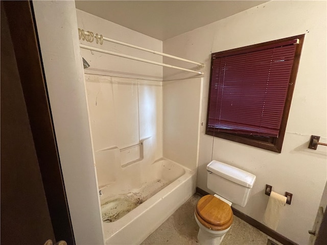 bathroom featuring shower / tub combination and toilet