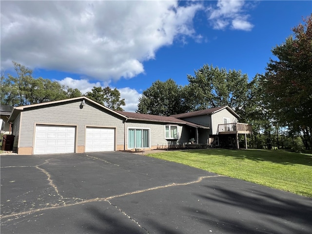 view of front of home with a front yard and a garage