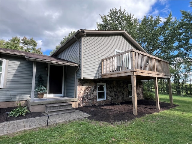 rear view of property featuring a lawn