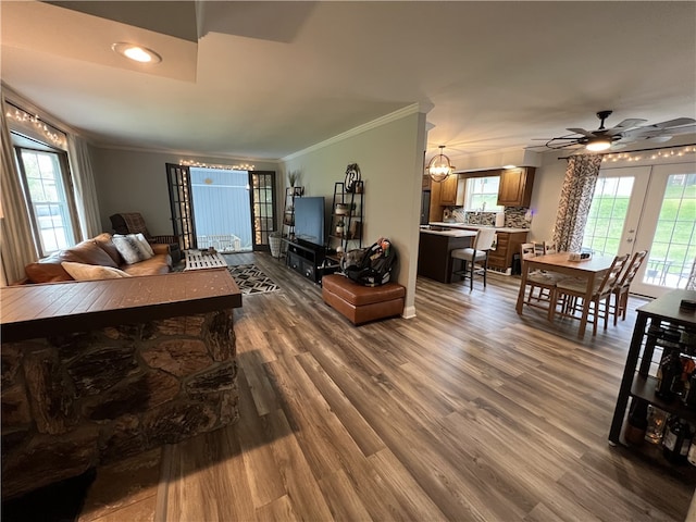 living room featuring french doors, ornamental molding, hardwood / wood-style flooring, and ceiling fan