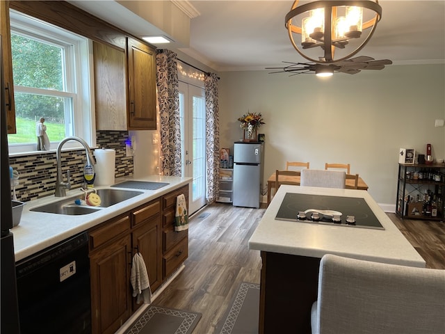 kitchen featuring crown molding, dark hardwood / wood-style floors, and black appliances