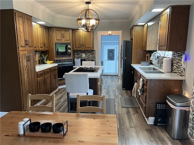 kitchen with sink, black appliances, dark wood-type flooring, and tasteful backsplash