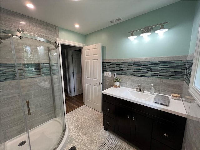 384 Grove Rd, Jefferson Twp Mer, PA 16137 - full bath featuring visible vents, a sink, tile walls, and a shower stall