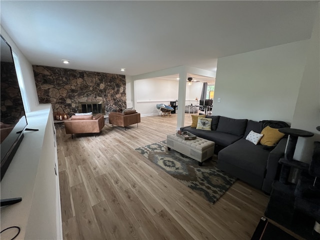 living room with wood-type flooring and a fireplace