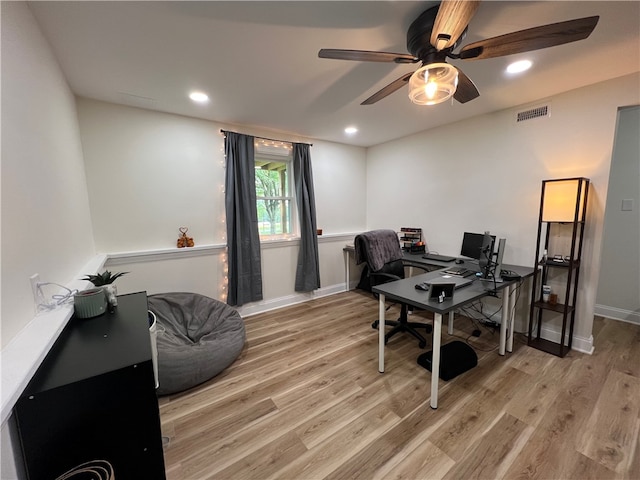 office with light hardwood / wood-style flooring and ceiling fan