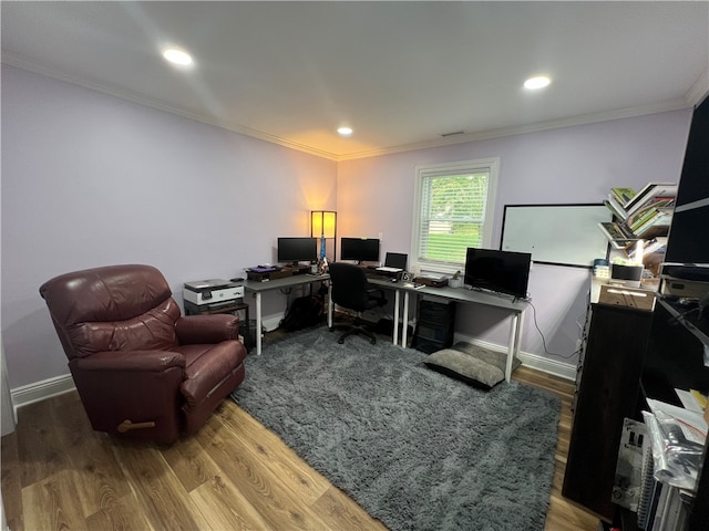 home office with crown molding and wood-type flooring