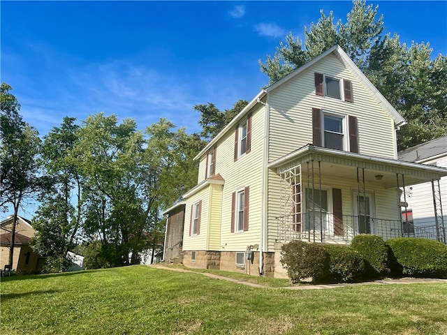 view of property exterior with a porch and a lawn