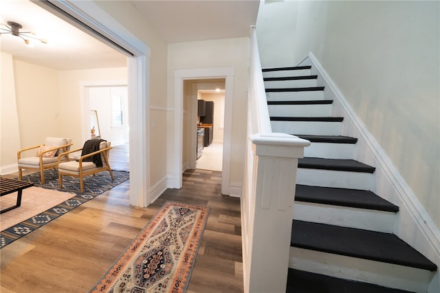 stairway featuring wood-type flooring